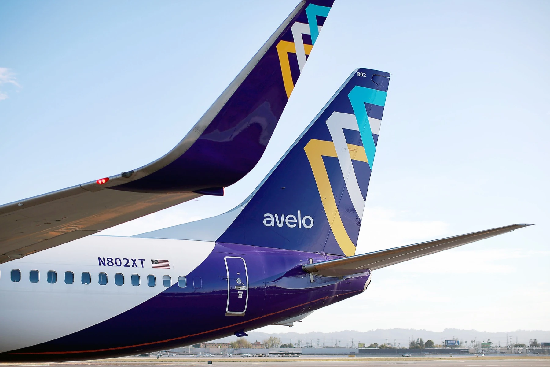 An Avelo Airlines aircraft tail on the ramp, showing the airline livery.