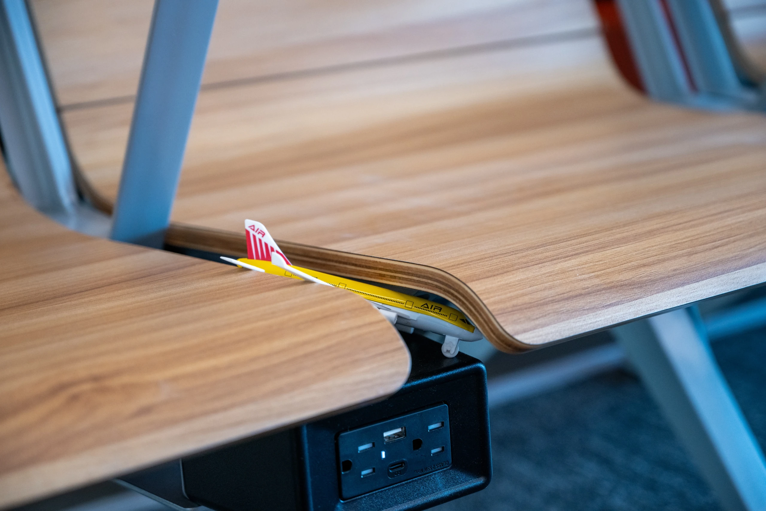 A toy airplane left behind on a seat in the terminal.